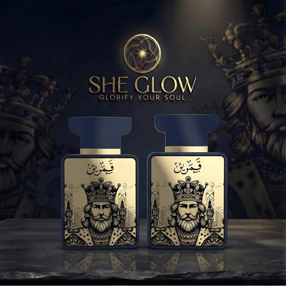 Two rectangular perfume bottles labeled SHE GLOW with a gold crown illustration and Arabic calligraphy, displayed on a dark reflective surface against a dark background with crown imagery.