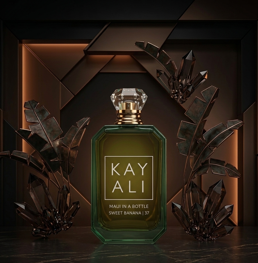 Kayali perfume bottle with decorative plants on a dark background