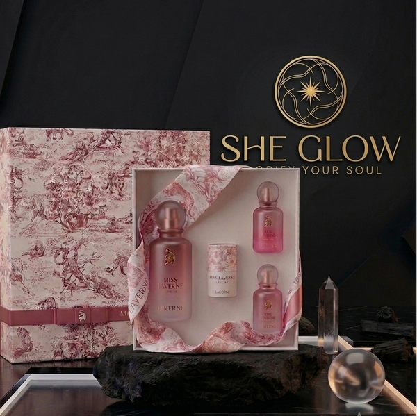 She Glow beauty product set with decorative box on a dark surface