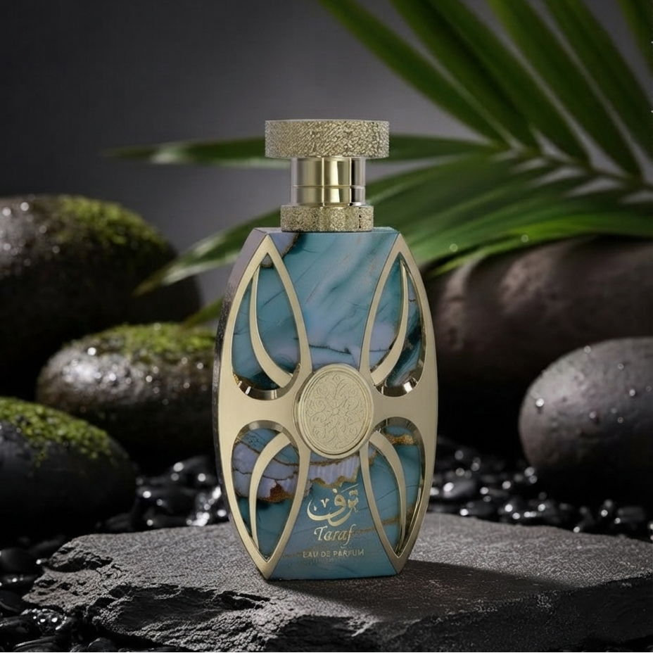 A decorative perfume bottle labeled 'Taraj' stands on a dark stone slab surrounded by wet black pebbles, mossy rocks, and green leaves against a dark studio background. SHE GLOW