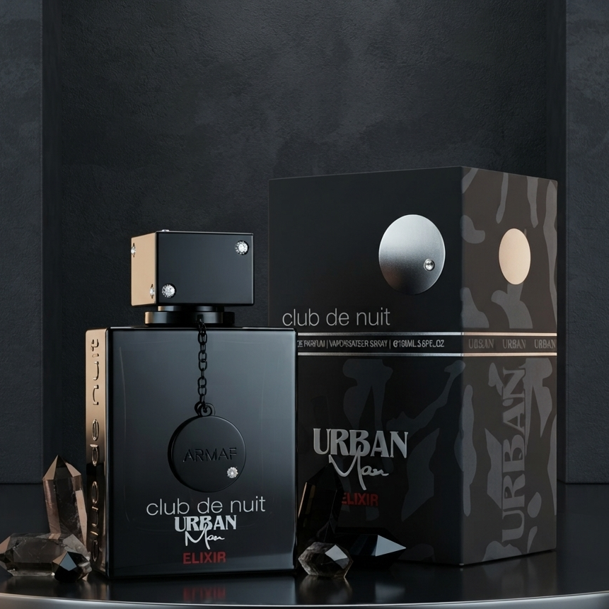 Urban Men Club de Nuit perfume bottle and its packaging box displayed on a reflective black surface against a dark gray background. SHE GLOW 