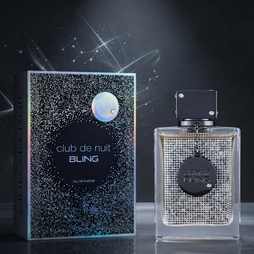 Club de Nuit Bling Eau de Parfum bottle and its packaging box, featuring a sparkling silver rhinestone pattern with a holographic iridescent moon graphic on the box. SHE GLOW