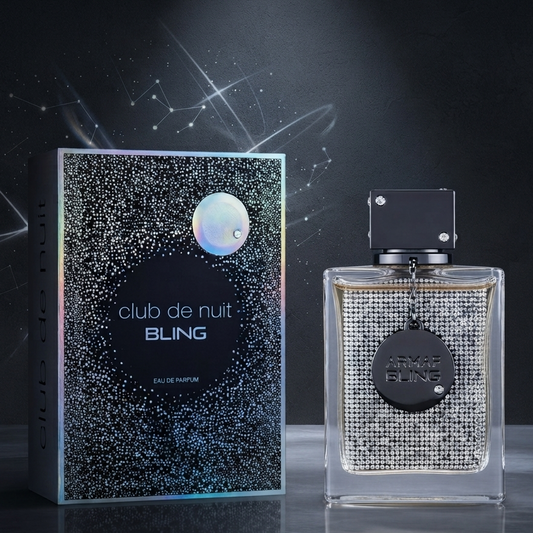 Club de Nuit Bling Eau de Parfum bottle and its packaging box, featuring a sparkling silver rhinestone pattern with a holographic iridescent moon graphic on the box. SHE GLOW