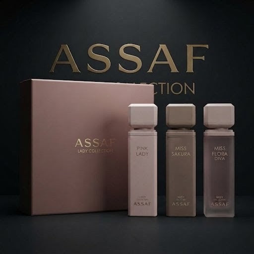 ASSAF Lady Collection fragrance set featuring a dusty rose box and three rectangular glass bottles in soft pink, taupe, and grayish tones, with large ASSAF branding on the backdrop. SHE GLOW
