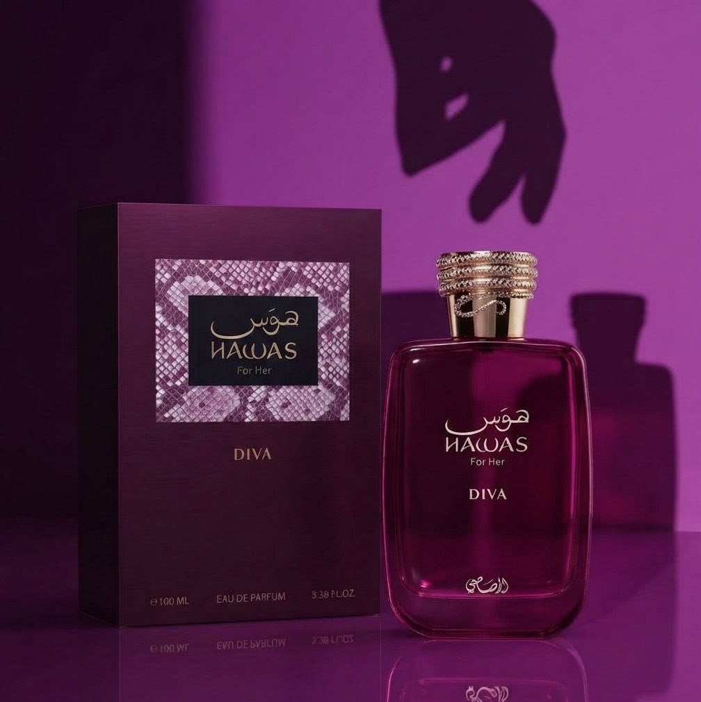 A bottle of DIVA Eau de Parfum next to its matching purple packaging box, featuring a snakeskin patterned label, set against a dark purple background with a hand shadow. SHE GLOW ✨