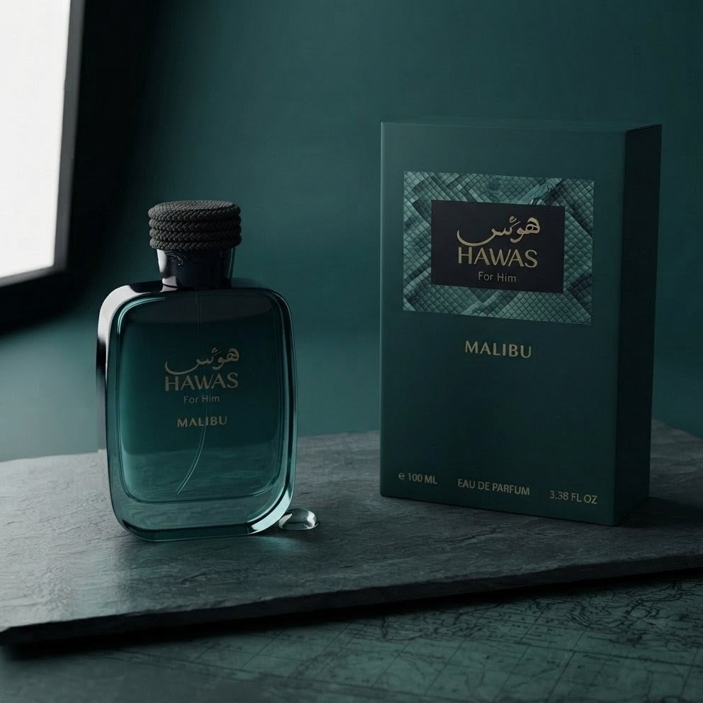 A bottle of Hawas For Men Malibu cologne next to its retail box, both in a dark teal color, displayed on a dark slate surface.
SHE GLOW ✨