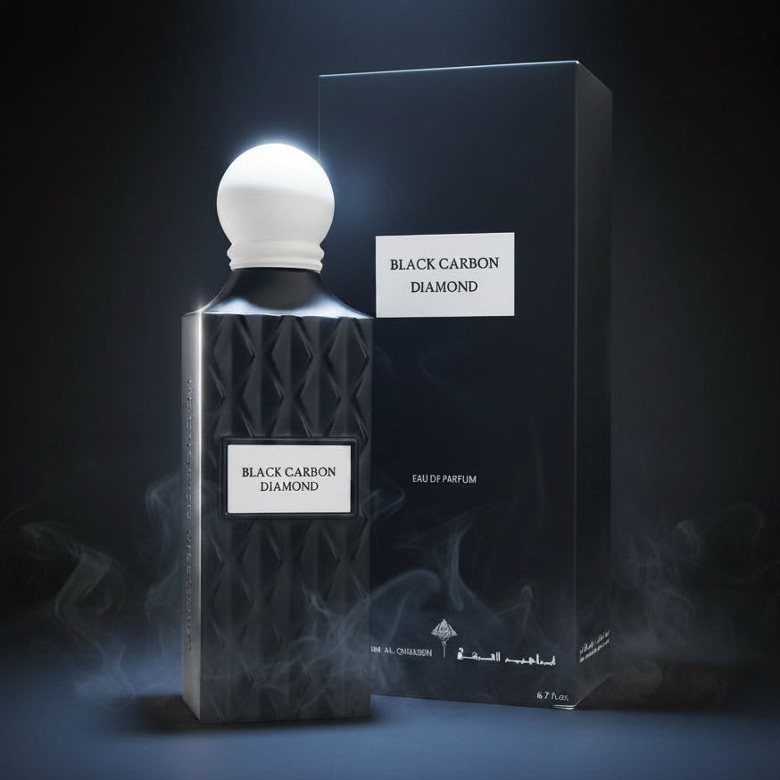 Black Carbon Diamond Eau de Parfum bottle with a textured black body and white spherical cap, shown next to its black packaging box with a white label. SHE GLOW ✨