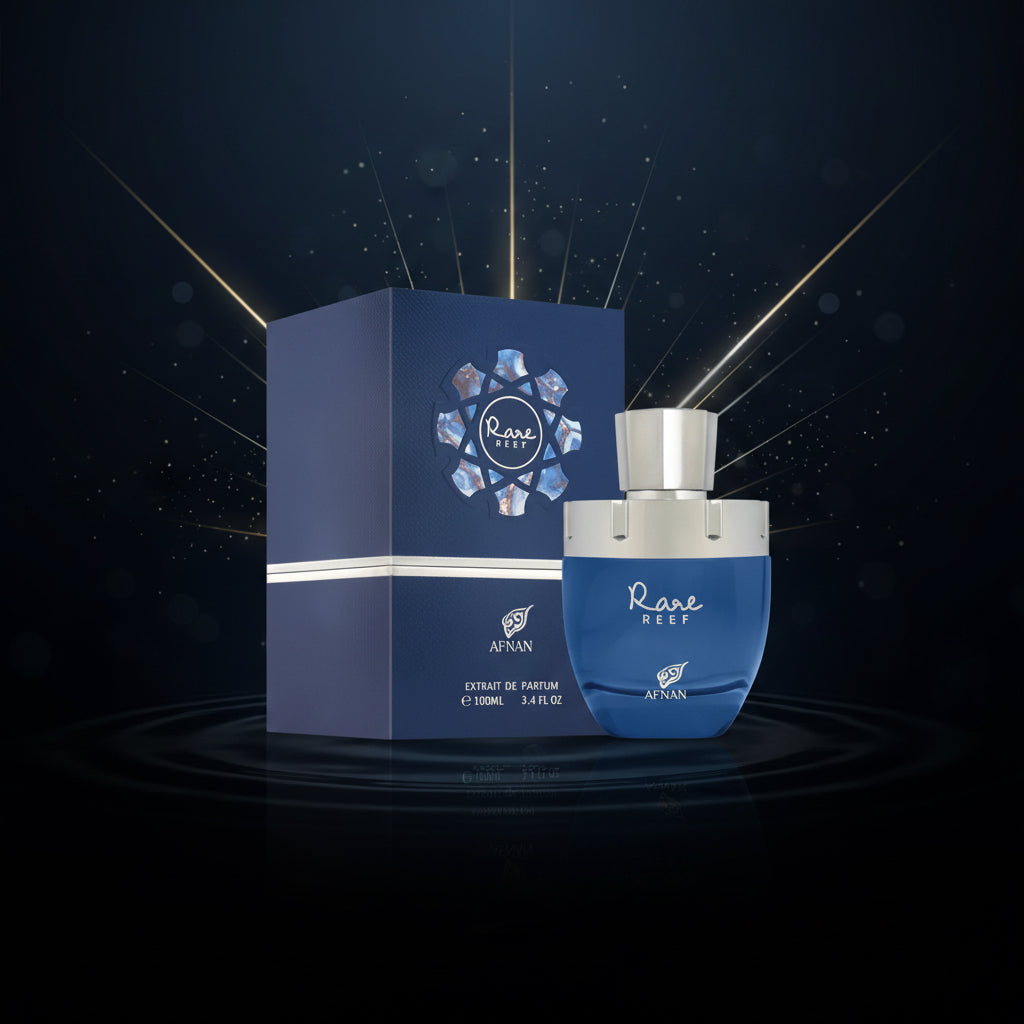A bottle of Afnan Rare Reef Extrait de Parfum next to its dark blue packaging box, set against a light gray background. SHE GLOW 