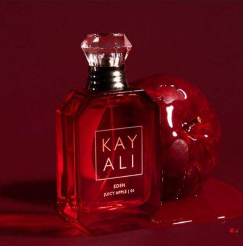 Red perfume bottle labeled 'KAY ALI' with an apple on a red background