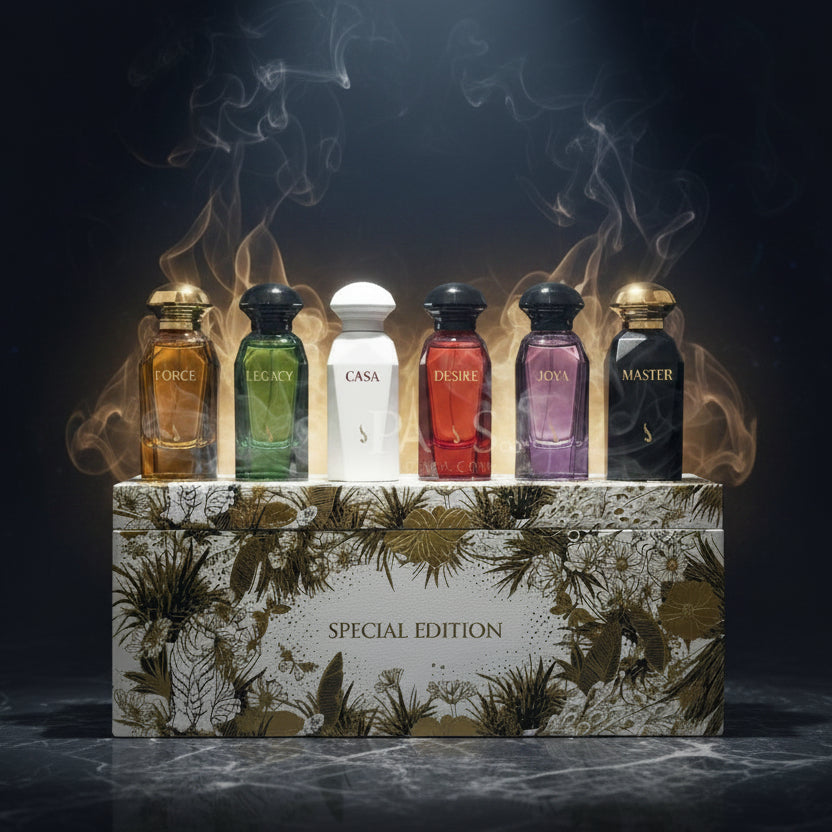 Six perfume bottles in different colors (gold, green, white, red, purple, black) lined up on top of a decorative floral-patterned box labeled 'SPECIAL EDITION'.    SHE GLOW ✨