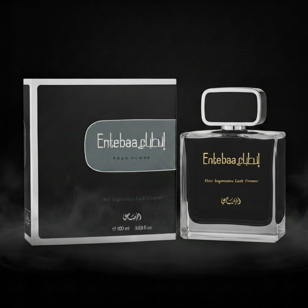 Entebaa Public Pour Homme fragrance shown with its black and white retail box and a clear glass bottle featuring a black label and gold lettering, on a light gray background.SHE GLOW ✨