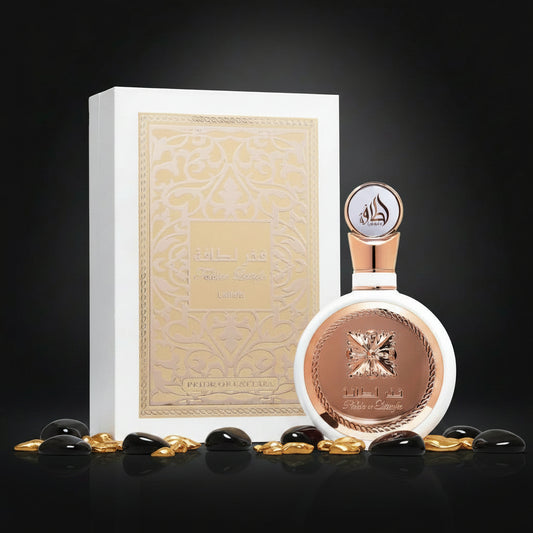 A perfume bottle with a rose gold cap and a round rose gold medallion, shown next to its white and gold presentation box. The bottle features Arabic text reading 'مطر لطافة' and 'Prince George', with 'Prince George' also visible on the box.
 SHE GLOW ✨