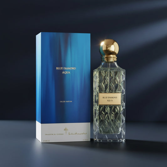 Blue Diamond Aqua Eau de Parfum bottle with a faceted clear glass body and gold cap, shown next to its blue box packaging on a white background. SHE GLOW ✨