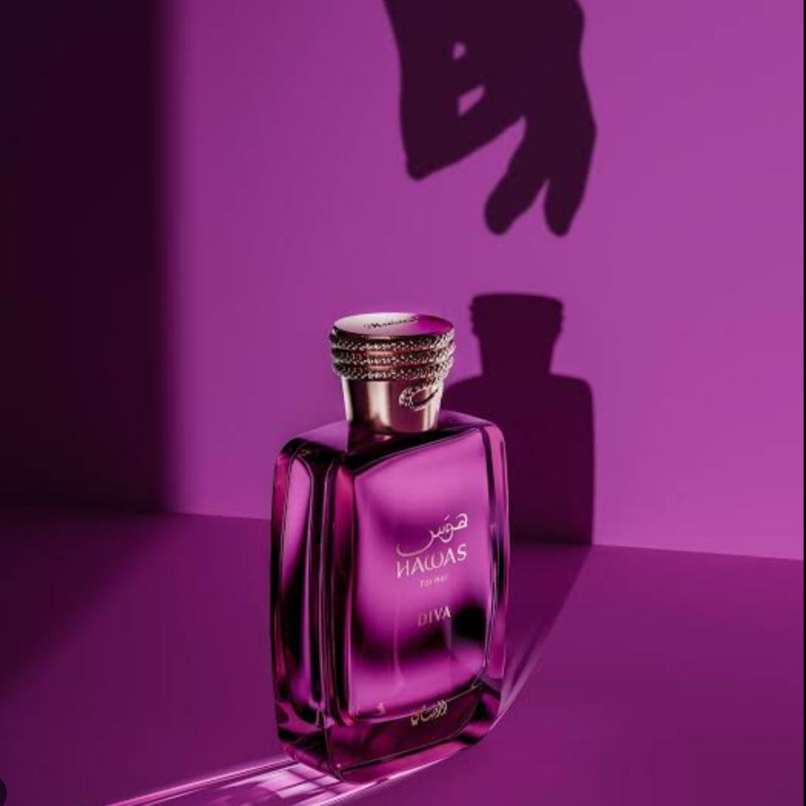 A rectangular glass perfume bottle with a metallic cap, labeled 'MAWAS LUMA', set against a dark purple background with dramatic shadows. SHE GLOW ✨